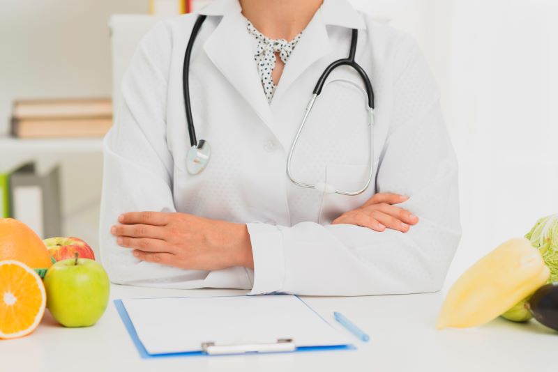 close-up-doctor-with-stethoscope-and-fruits